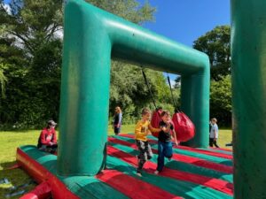 Cub Scouts running across an inflatable